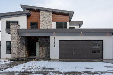 Inspiration for a modern white three-story mixed siding exterior home remodel in Other