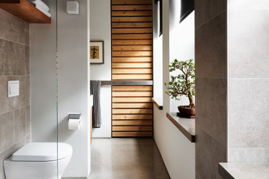 Bathroom - mid-sized modern concrete floor and single-sink bathroom idea in Boston with a wall-mount toilet and a floating vanity