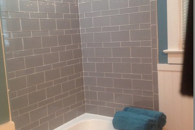 Example of a mid-sized trendy kids' gray tile and glass tile porcelain tile bathroom design in Other with white cabinets, a one-piece toilet and blue walls