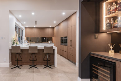 Photo of a contemporary u-shaped separate kitchen in Perth with flat-panel cabinets, light wood cabinets, quartz benchtops and white benchtop.