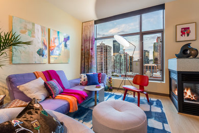 Inspiration for a small eclectic open concept bamboo floor living room remodel in Seattle with yellow walls, a two-sided fireplace and a tile fireplace