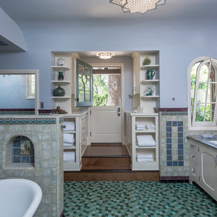 Freestanding bathtub - beach style master blue tile and ceramic tile mosaic tile floor freestanding bathtub idea in Los Angeles with recessed-panel cabinets, white cabinets, a one-piece toilet, blue walls, an undermount sink and zinc countertops