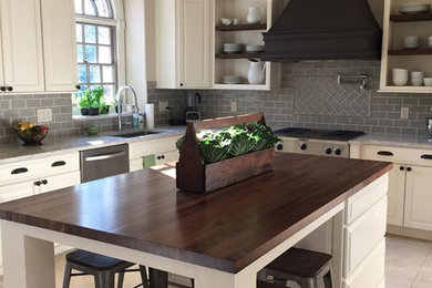 Large transitional kitchen photo in Chicago with an undermount sink, raised-panel cabinets, white cabinets, quartzite countertops, gray backsplash, subway tile backsplash, stainless steel appliances and an island