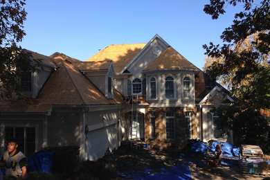 Inspiration for a large transitional three-story mixed siding gable roof remodel in Charlotte