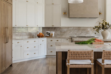 Kitchen - large transitional kitchen idea in Jacksonville with an undermount sink, shaker cabinets, quartzite countertops, stone slab backsplash, paneled appliances and two islands