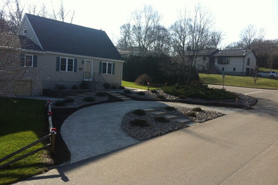 This is an example of a mid-sized traditional partial sun front yard brick driveway in Providence.