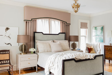 Photo of a traditional master bedroom in Boston with grey walls and medium hardwood floors.