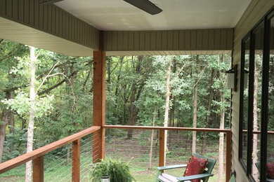 Example of a small transitional deck design in Chicago with a roof extension