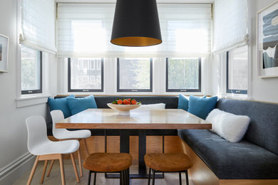 Breakfast nook - contemporary light wood floor and beige floor breakfast nook idea in San Francisco with white walls