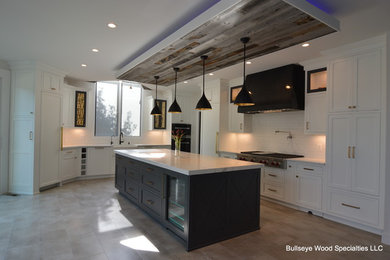 Inspiration for a large transitional l-shaped porcelain tile and beige floor open concept kitchen remodel in DC Metro with a farmhouse sink, recessed-panel cabinets, white cabinets, quartz countertops, white backsplash, ceramic backsplash, paneled appliances, an island and white countertops