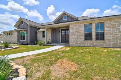 Example of a mid-sized eclectic blue one-story mixed siding house exterior design in Austin with a shingle roof