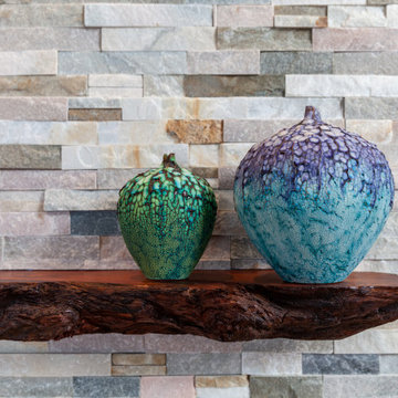 Live Edge Mantel with Ceramic Art on Stacked Stone Fireplace – Rockport Cottage