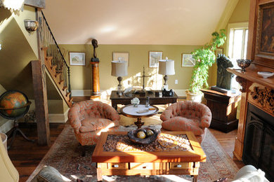 Mid-sized traditional living room in Boston with green walls, dark hardwood floors and a wood fireplace surround.