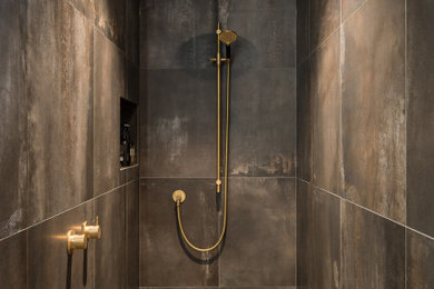 Inspiration for a mid-sized industrial master bathroom in Perth with flat-panel cabinets, distressed cabinets, an open shower, porcelain tile, black walls, concrete floors, solid surface benchtops, black floor, an open shower, a niche and a floating vanity.