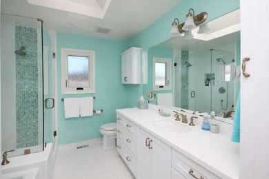 Mid-sized transitional master bathroom in Other with shaker cabinets, white cabinets, an alcove tub, a corner shower, a two-piece toilet, blue tile, glass tile, blue walls, an undermount sink, quartzite benchtops, white floor and a hinged shower door.