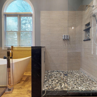 Design ideas for a large traditional master bathroom in Philadelphia with recessed-panel cabinets, dark wood cabinets, a freestanding tub, a corner shower, a two-piece toilet, beige tile, blue walls, laminate floors, a vessel sink, brown floor, an open shower, beige benchtops, a double vanity, a built-in vanity, vaulted and wood walls.