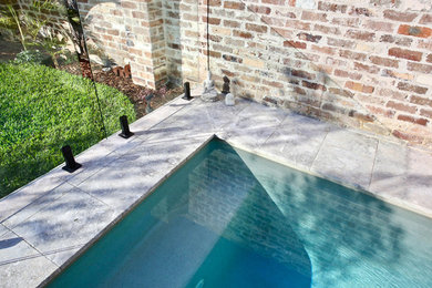 Photo of a small modern backyard rectangular pool in Sydney with a pool house.
