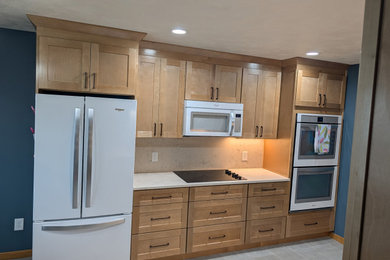 Example of a mid-sized transitional eat-in kitchen design in Other with shaker cabinets, light wood cabinets, quartz countertops and quartz backsplash