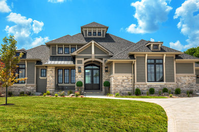 Large transitional gray one-story mixed siding house exterior photo in Other with a hip roof and a shingle roof