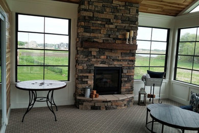 This is an example of a large rustic back porch design in Minneapolis with decking.
