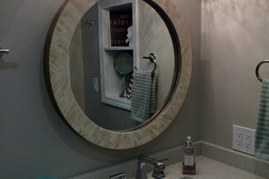 Doorless shower - mid-sized transitional 3/4 gray tile and porcelain tile vinyl floor doorless shower idea in Cleveland with an undermount sink, shaker cabinets, gray cabinets, quartz countertops, a one-piece toilet and gray walls