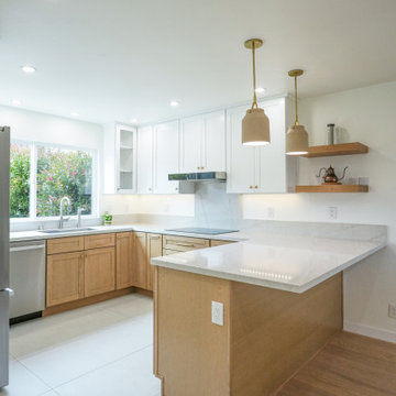 Modern White and Natural Oak Kitchen with Brass Hardware and Quartz Backsplash