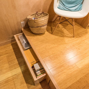 Design ideas for a small modern home studio in Los Angeles with white walls, bamboo flooring and a freestanding desk.