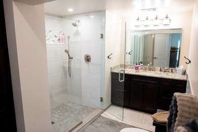 Bathroom - mid-sized rustic kids' gray tile and porcelain tile porcelain tile, single-sink and wainscoting bathroom idea in DC Metro with recessed-panel cabinets, dark wood cabinets, an undermount sink, granite countertops, a hinged shower door, white countertops, a niche and a built-in vanity