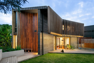 Inspiration for an expansive contemporary two-storey grey house exterior in Melbourne with a flat roof.