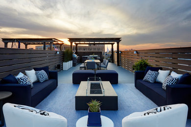 Inspiration for a large contemporary rooftop deck remodel in Chicago with a fire pit and no cover