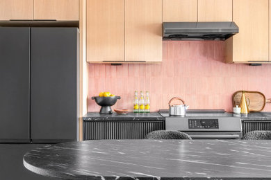 1950s kitchen photo in Miami with flat-panel cabinets, light wood cabinets and an island