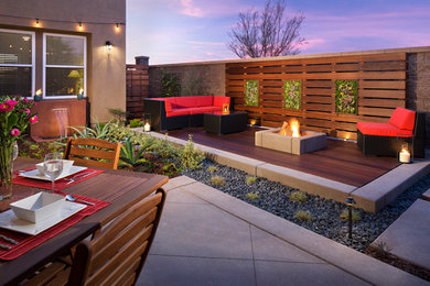 Design ideas for a small contemporary backyard landscaping in San Diego with decking for spring.