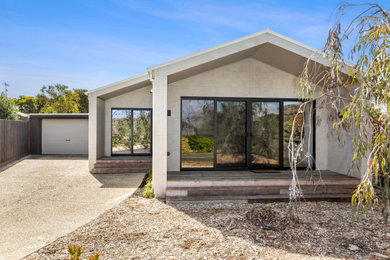 Design ideas for a modern grey house exterior in Geelong with a gable roof and a metal roof.