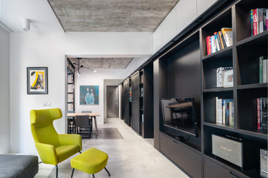 Example of a mid-sized urban open concept gray floor living room design in London with white walls and a media wall