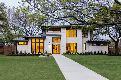 Large contemporary two-storey brick white exterior in Dallas with a hip roof.