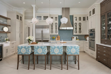 Inspiration for a large transitional u-shaped light wood floor and beige floor eat-in kitchen remodel in Tampa with flat-panel cabinets, beige cabinets, marble countertops, blue backsplash, glass tile backsplash, stainless steel appliances, an island and multicolored countertops