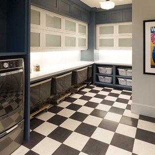 Design ideas for an expansive country l-shaped separated utility room in Salt Lake City with glass-front cabinets, white cabinets, engineered stone countertops, grey walls, porcelain flooring, a side by side washer and dryer, multi-coloured floors and white worktops.