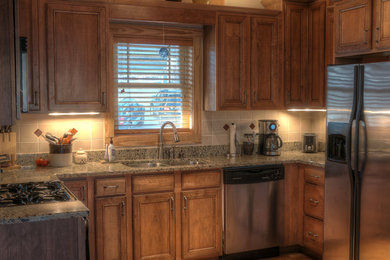Enclosed kitchen - small craftsman u-shaped light wood floor enclosed kitchen idea in Raleigh with a double-bowl sink, beaded inset cabinets, light wood cabinets, granite countertops, ceramic backsplash, stainless steel appliances and no island