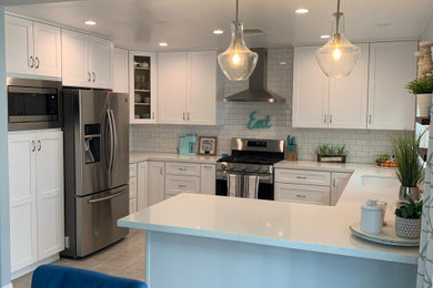 Example of a mid-sized eclectic u-shaped eat-in kitchen design in Los Angeles with shaker cabinets, white cabinets, quartzite countertops, white backsplash, subway tile backsplash, a peninsula and white countertops