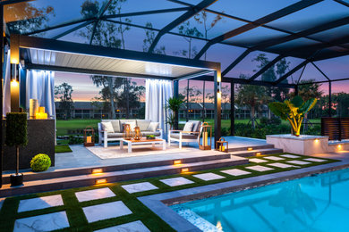 Inspiration for a mid-sized modern backyard tile patio kitchen remodel in Miami with a pergola