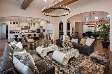 Inspiration for a large transitional open concept family room in Phoenix with white walls, light hardwood floors and brown floor.