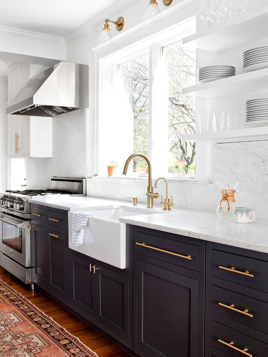 Transitional kitchen appliance - Transitional medium tone wood floor kitchen photo in Baltimore with a farmhouse sink, shaker cabinets, black cabinets, marble countertops, stainless steel appliances and marble backsplash