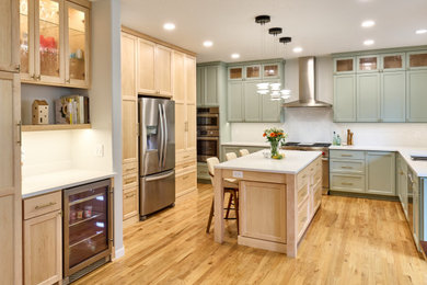 Inspiration for a transitional u-shaped beige floor eat-in kitchen remodel in Other with a double-bowl sink, green cabinets, quartzite countertops, white backsplash, porcelain backsplash, stainless steel appliances, an island and white countertops