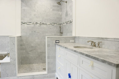 Elegant master gray tile and subway tile marble floor and gray floor corner shower photo in Boston with white walls and marble countertops