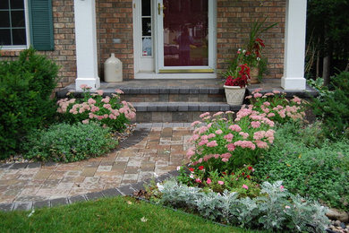 Inspiration for a mid-sized traditional partial sun front yard brick driveway in Minneapolis.