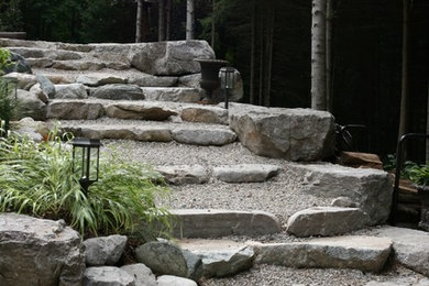 Photo of a rustic backyard stone landscaping in Toronto.
