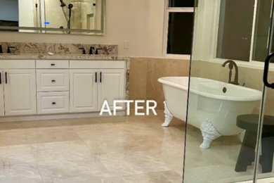 Minimalist travertine floor and double-sink claw-foot bathtub photo in Los Angeles with raised-panel cabinets, white cabinets, an undermount sink, granite countertops, a hinged shower door and a built-in vanity