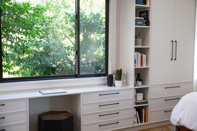 Example of a mid-sized 1950s master medium tone wood floor bedroom design in San Francisco with white walls and no fireplace