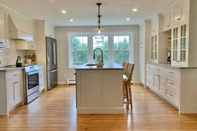 Transitional kitchen photo with an island and shaker cabinets