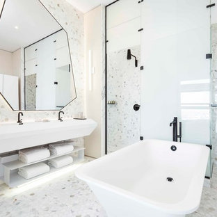 Bathroom - contemporary master stone tile and white tile porcelain floor and white floor bathroom idea in New York with white walls, a hinged shower door, open cabinets, white cabinets, solid surface countertops, white countertops and an integrated sink